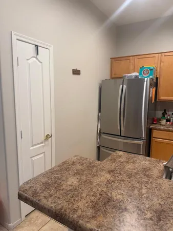 a view of a hallway with wooden floor and a bathroom