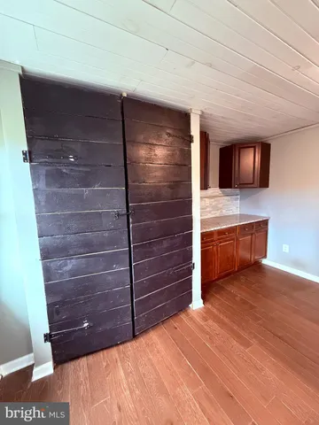 a view of room with wooden floor and window