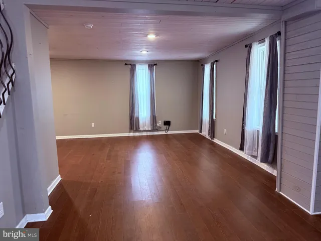 a view of room with window and wooden floor