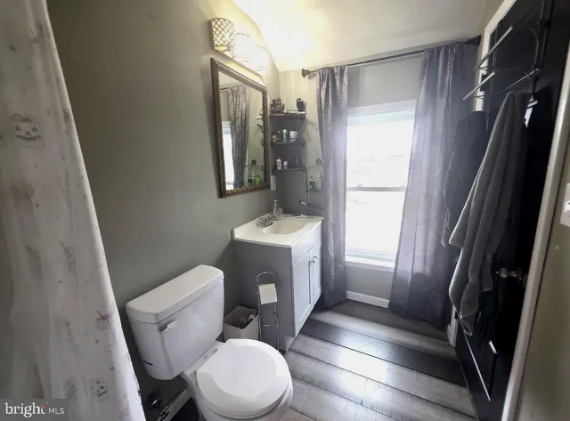 a white toilet sitting next to a bathroom sink