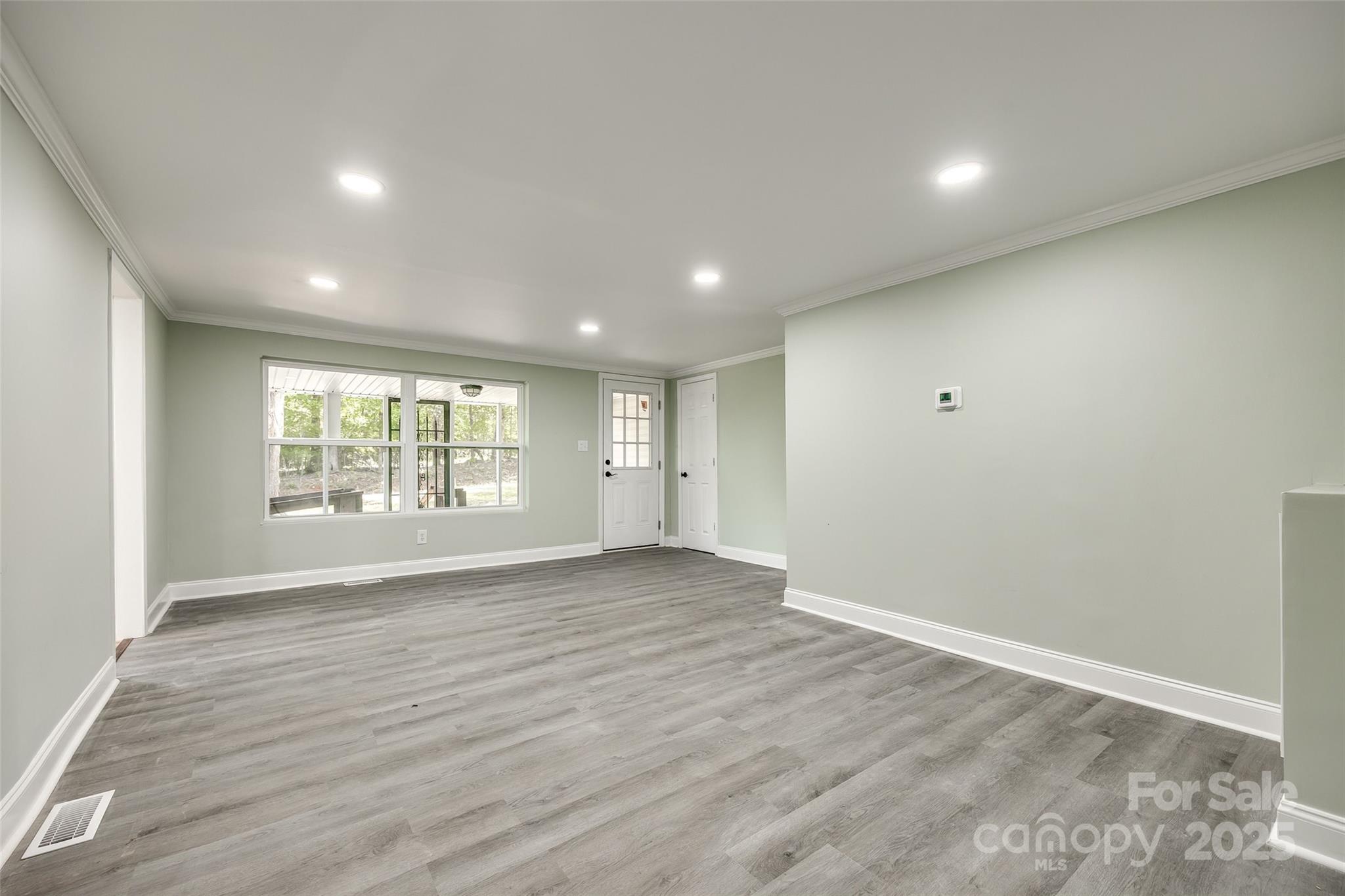 1224 Martin Road Hickory Grove, SC 29717 - Photo 13 of 40 an empty room with wooden floor and windows