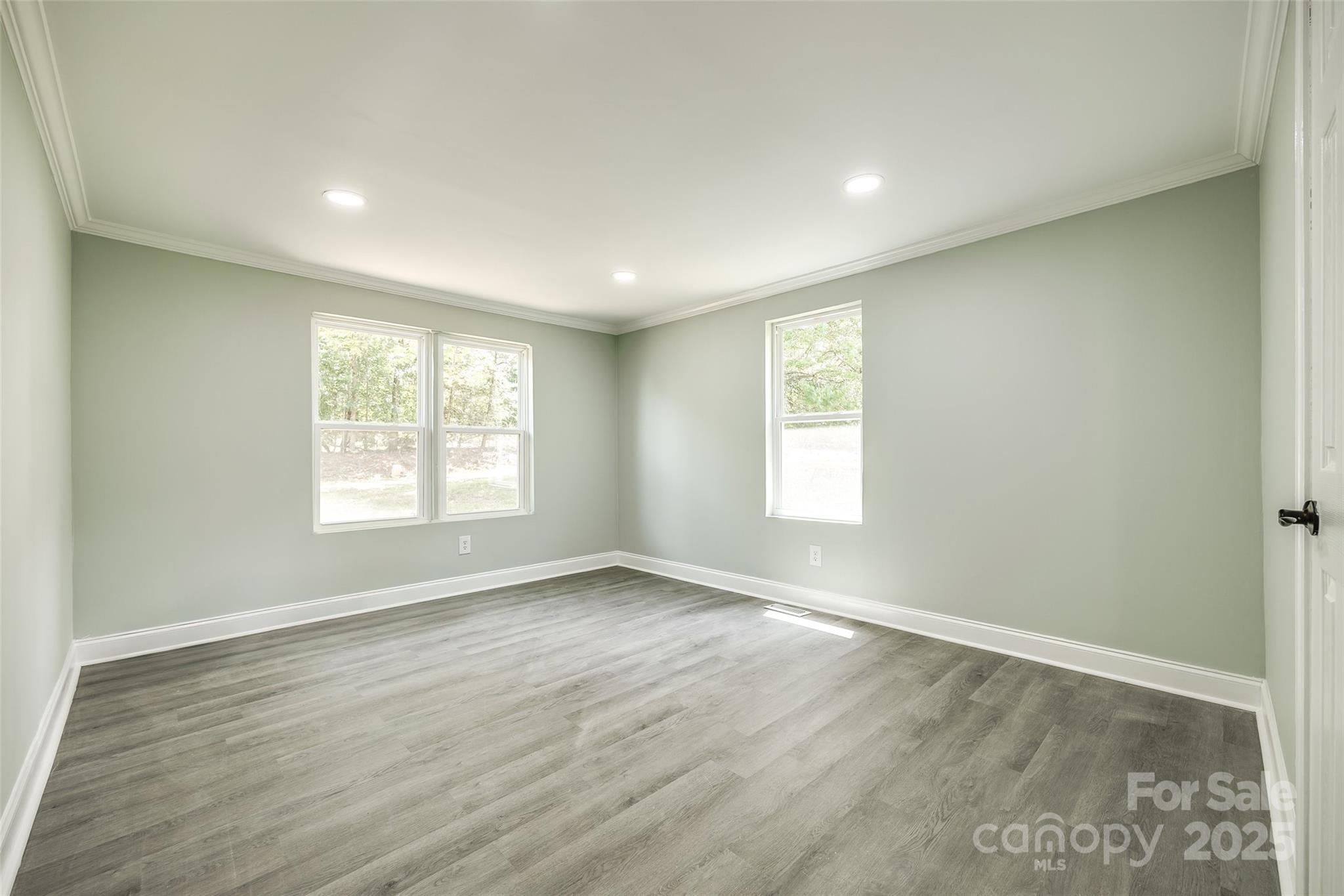 1224 Martin Road Hickory Grove, SC 29717 - Photo 16 of 40 an empty room with wooden floor and windows