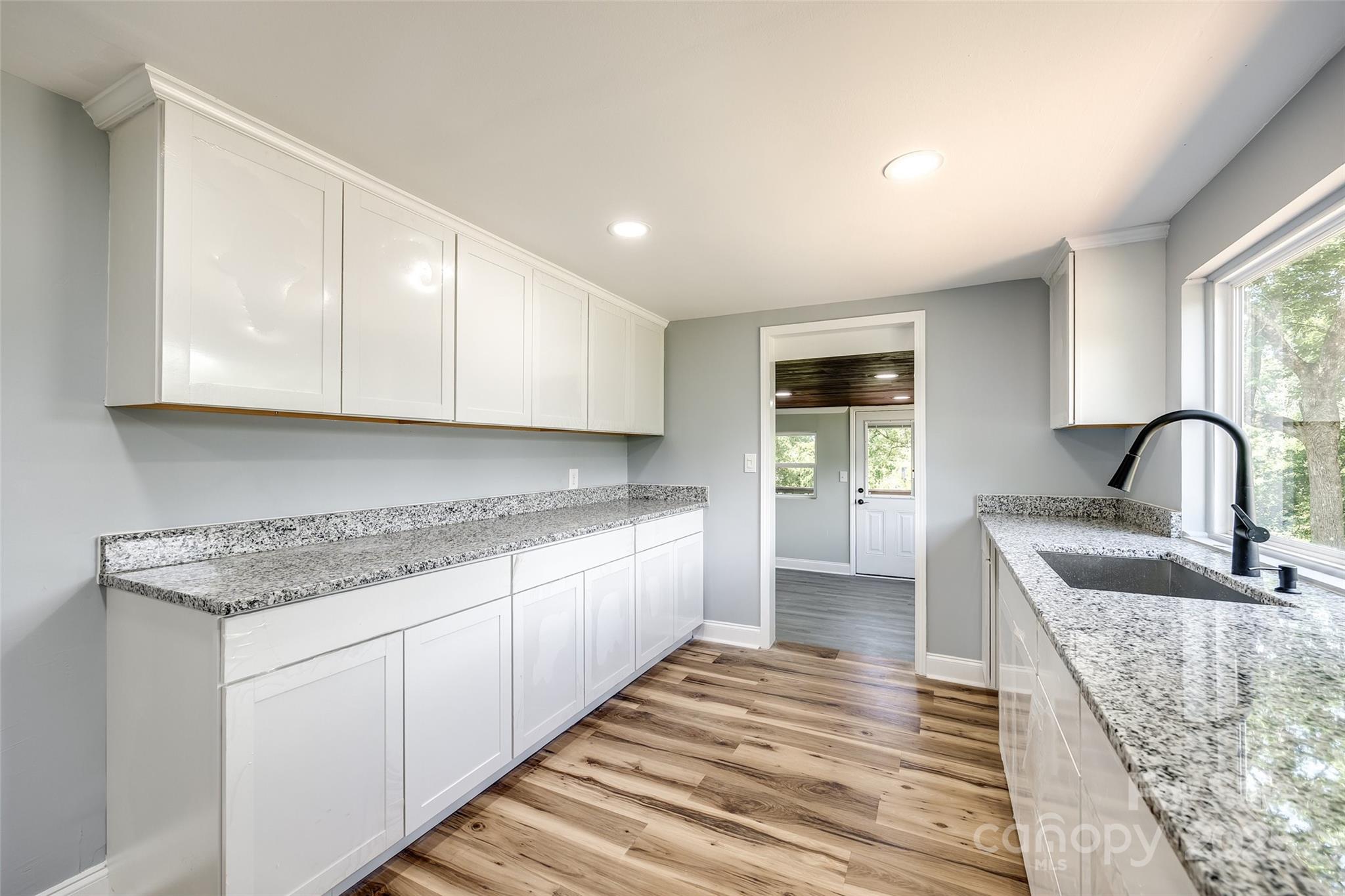 1224 Martin Road Hickory Grove, SC 29717 - Photo 21 of 40 a kitchen with stainless steel appliances granite countertop a stove a sink and a microwave