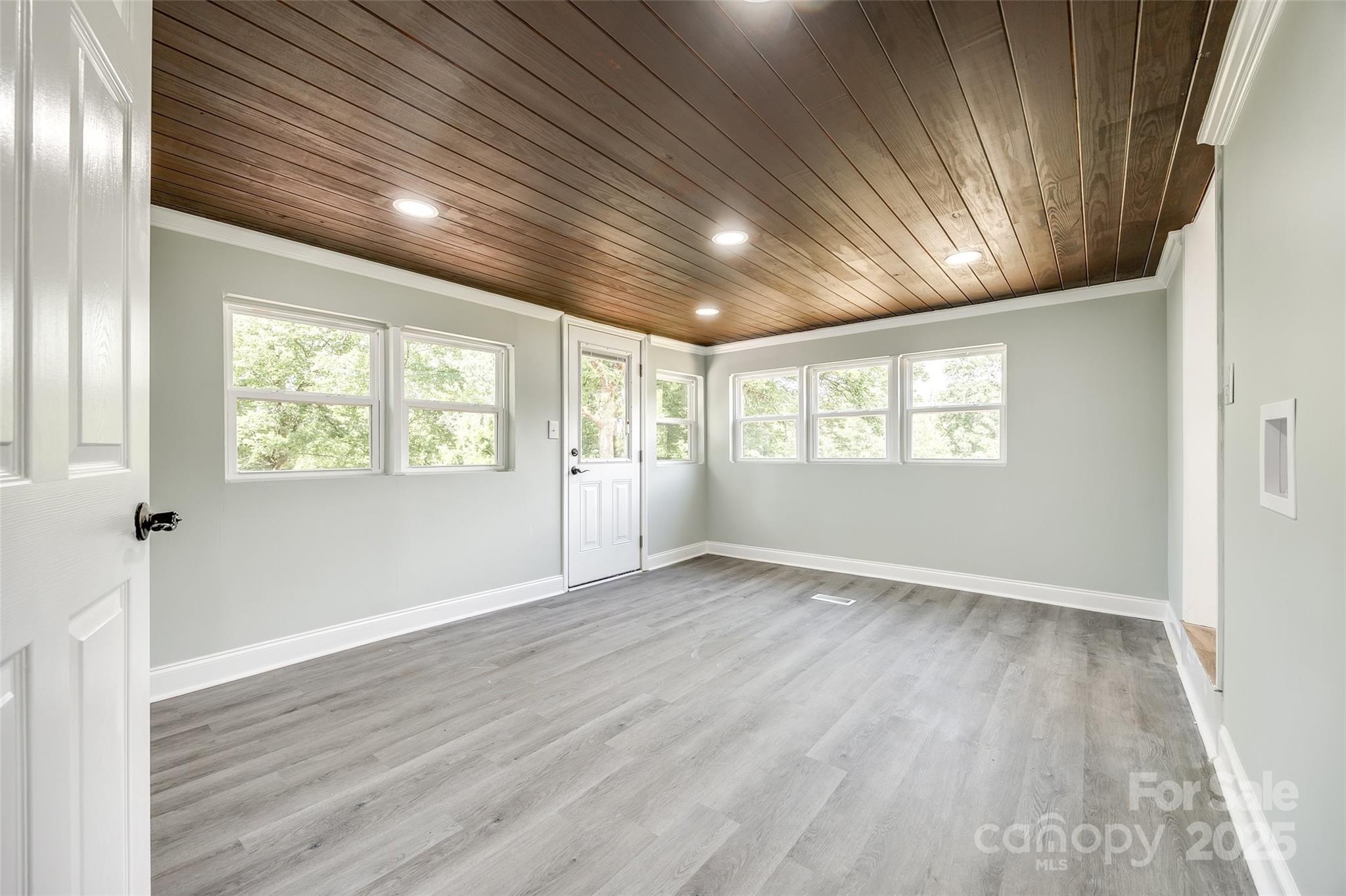 1224 Martin Road Hickory Grove, SC 29717 - Photo 26 of 40 an empty room with wooden floor and windows