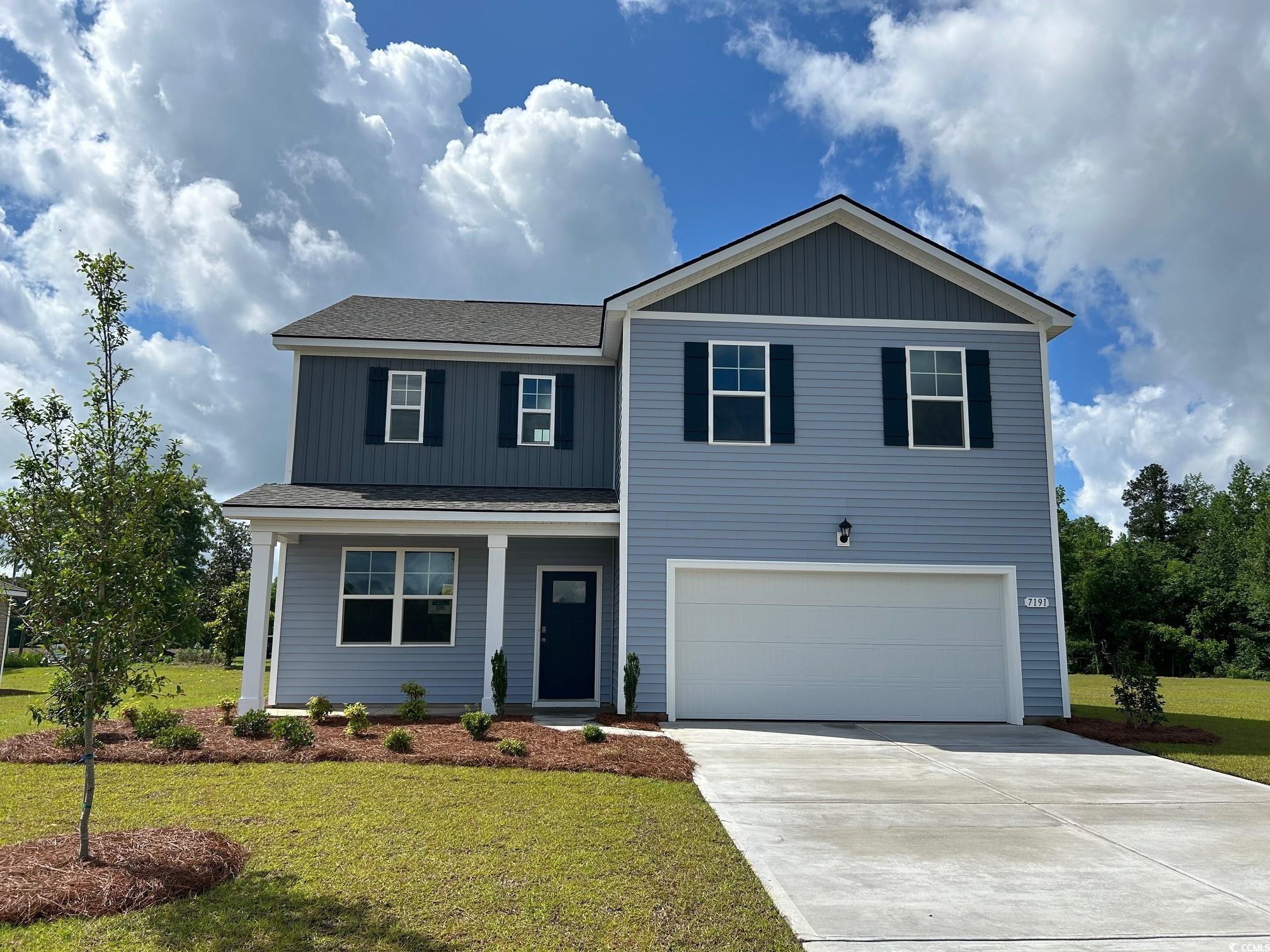 7191 Meadow Walk Loop Loris, SC 29569 - Photo 1 of 14 View of front of home with a garage, driveway, a f