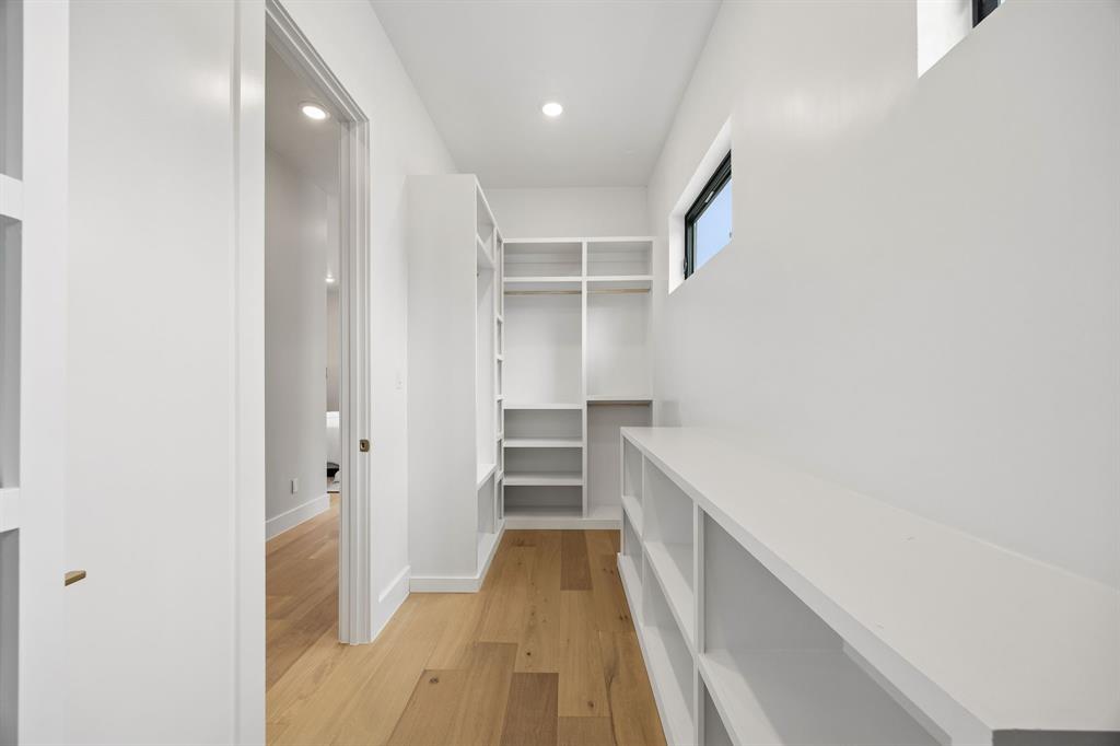 4615 Rusk Avenue Dallas, TX 75204 - Photo 18 of 25 a view of a hallway with wooden floor and staircase