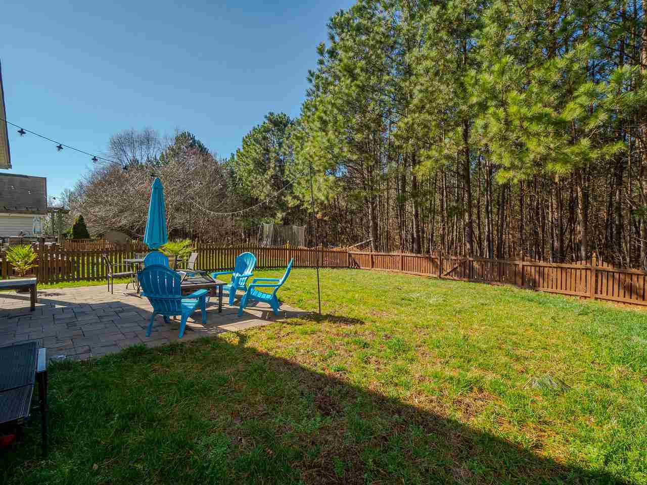 8429 Whisper Ridge Place Raleigh, NC 27613 - Photo 25 of 27 The fully fenced backyard is nicely level and backs to a beautiful common, wooded area. Backyard
