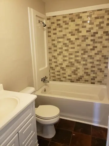 a bathroom with a toilet and a bathtub