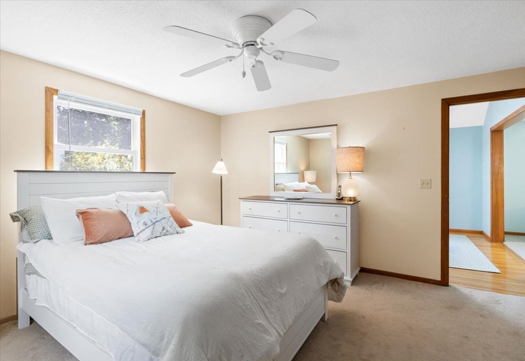 83 Brookside Road Rockland, MA 02370 - Photo 14 of 31 a bedroom with a bed and a chandelier