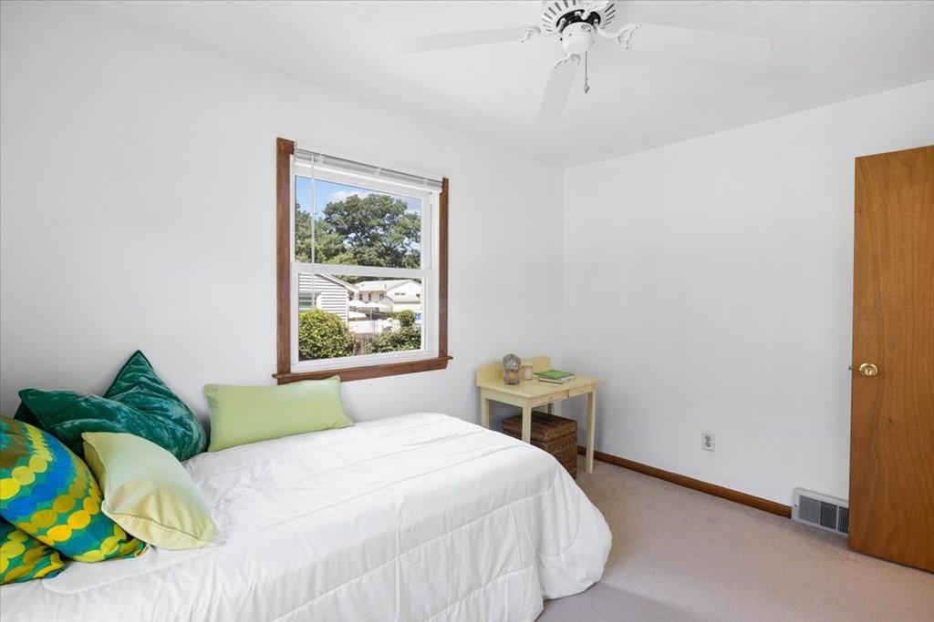 83 Brookside Road Rockland, MA 02370 - Photo 18 of 31 a bedroom with a bed table and a window