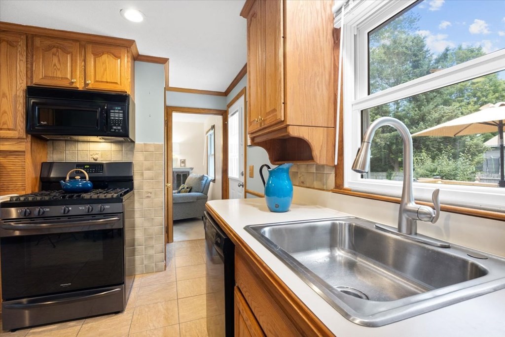 83 Brookside Road Rockland, MA 02370 - Photo 10 of 31 a kitchen with granite countertop a sink and a stove top oven