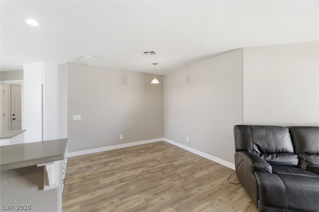 2780 West Simkins Road Pahrump, NV 89060 - Photo 10 of 40 Natural wood-look flooring and clean walls define this versatile living area, ready for your personal touch.
