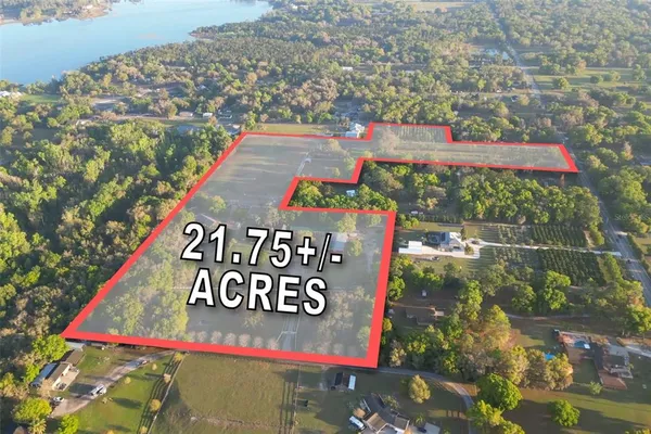 a view of yard with swimming pool and green space