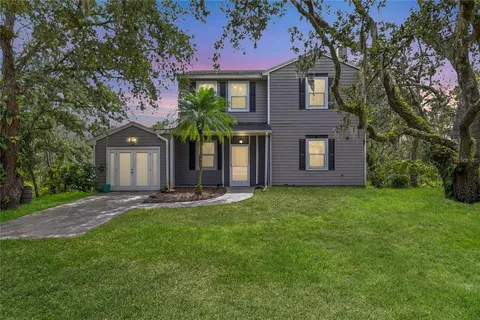 a front view of a house with a garden and yard