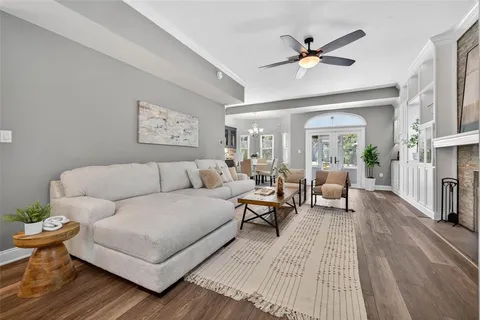 a living room with furniture a fireplace and a window
