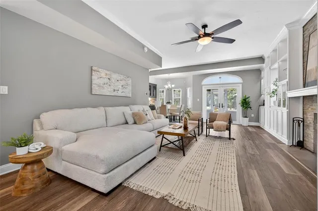 a living room with furniture a fireplace and a window
