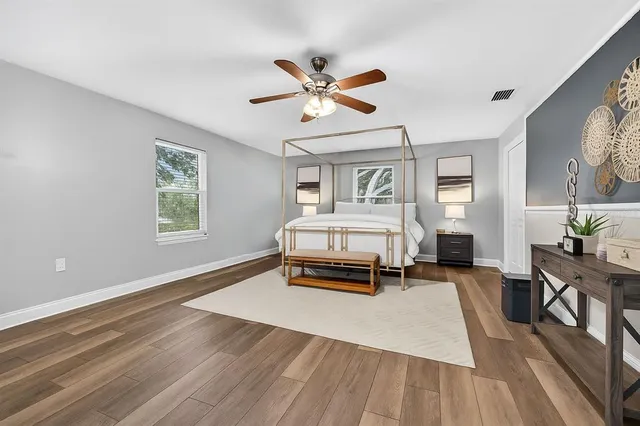 wooden floor in an empty room with a window
