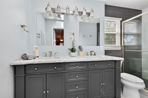 an empty room with a window and ceiling fan