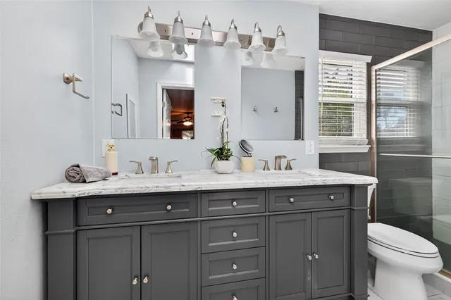 an empty room with a window and ceiling fan