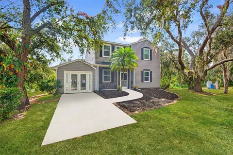 a front view of a house with yard porch and green space