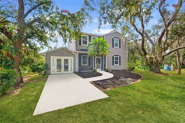 a front view of a house with yard porch and green space