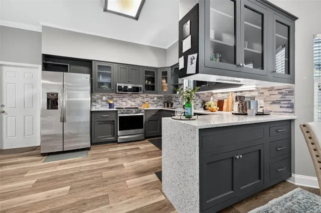a kitchen with stainless steel appliances granite countertop a stove and a refrigerator