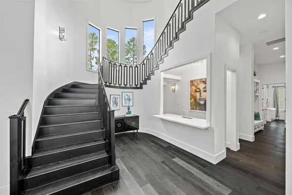 a view of entryway and hall with wooden floor
