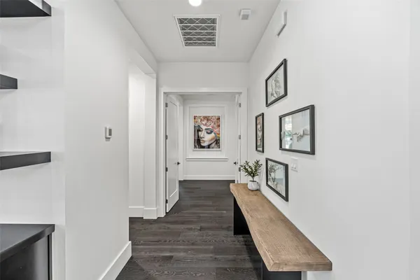 a view of a hallway with wooden floor windows and livingroom