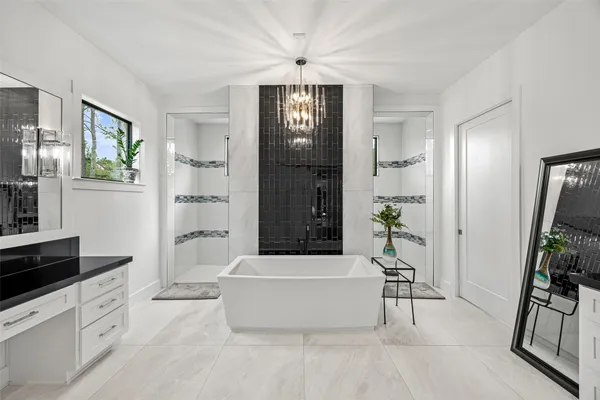 a kitchen with granite countertop a stove a sink and a refrigerator