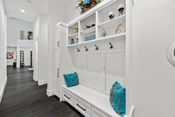 a kitchen with white cabinets and sink