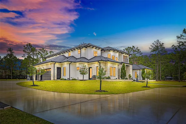 a view of a white house with a yard
