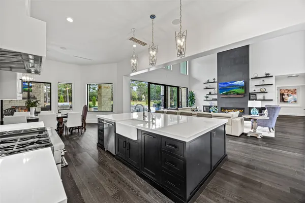 a large kitchen with kitchen island a sink a counter space and stainless steel appliances