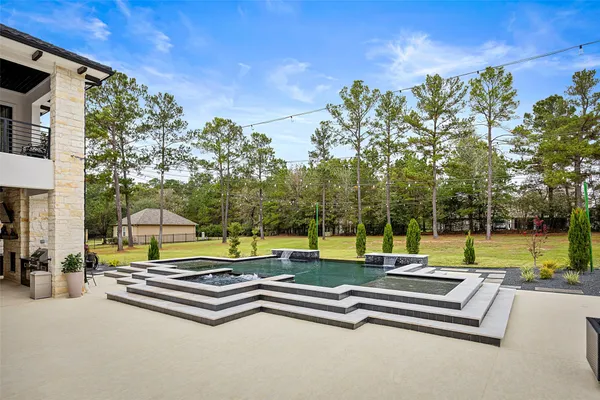 a balcony with furniture and potted plants