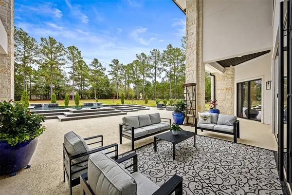 a view of a patio with swimming pool and yard