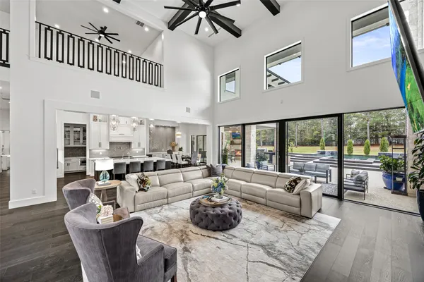 a living room with furniture and floor to ceiling windows