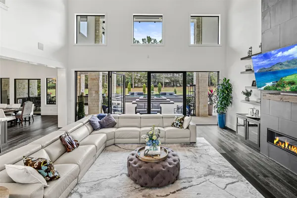 a living room with furniture and a floor to ceiling window