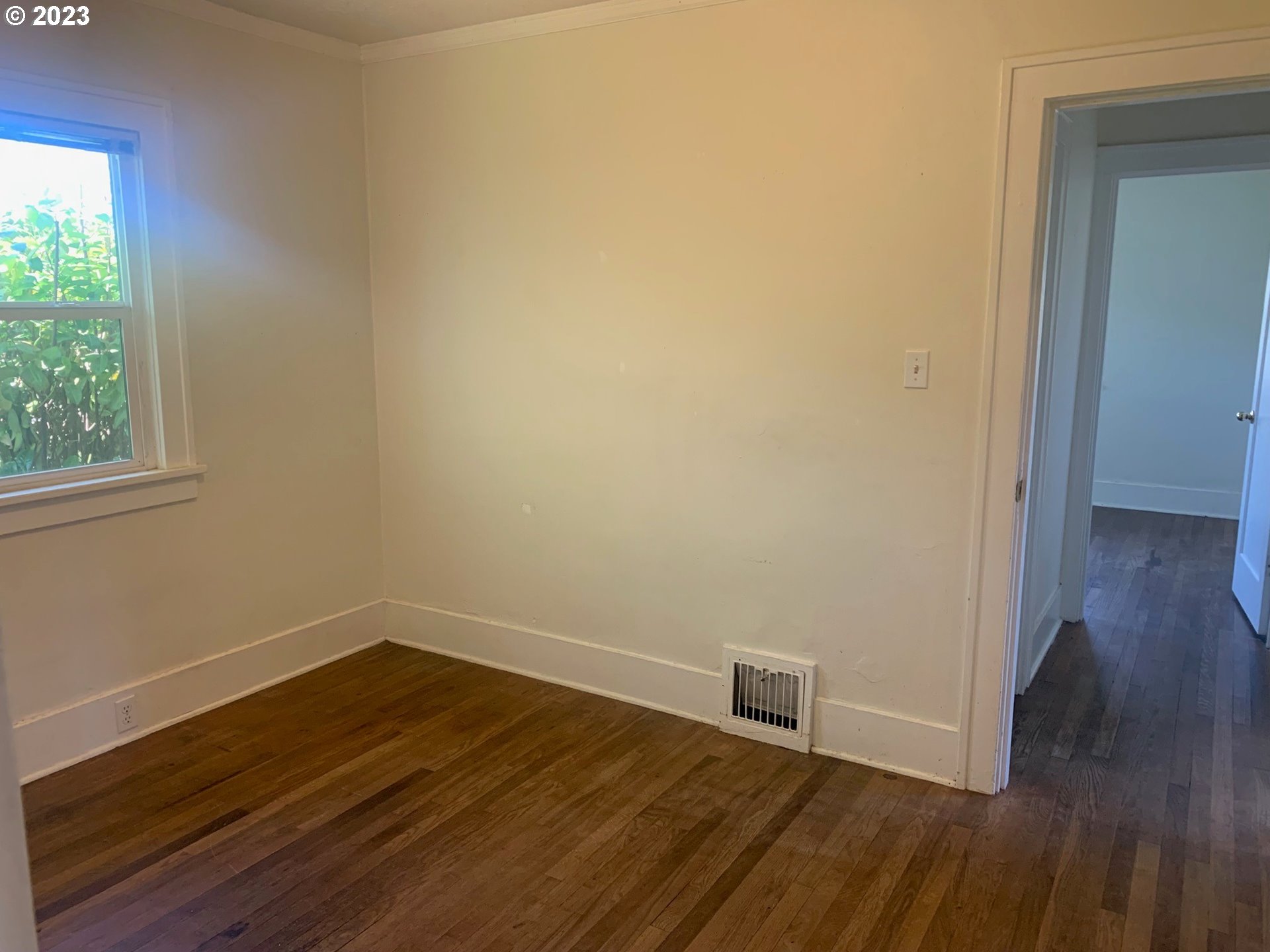 4005 Northeast 70th Avenue Portland, OR 97213 - Photo 13 of 27 an empty room with wooden floor and windows