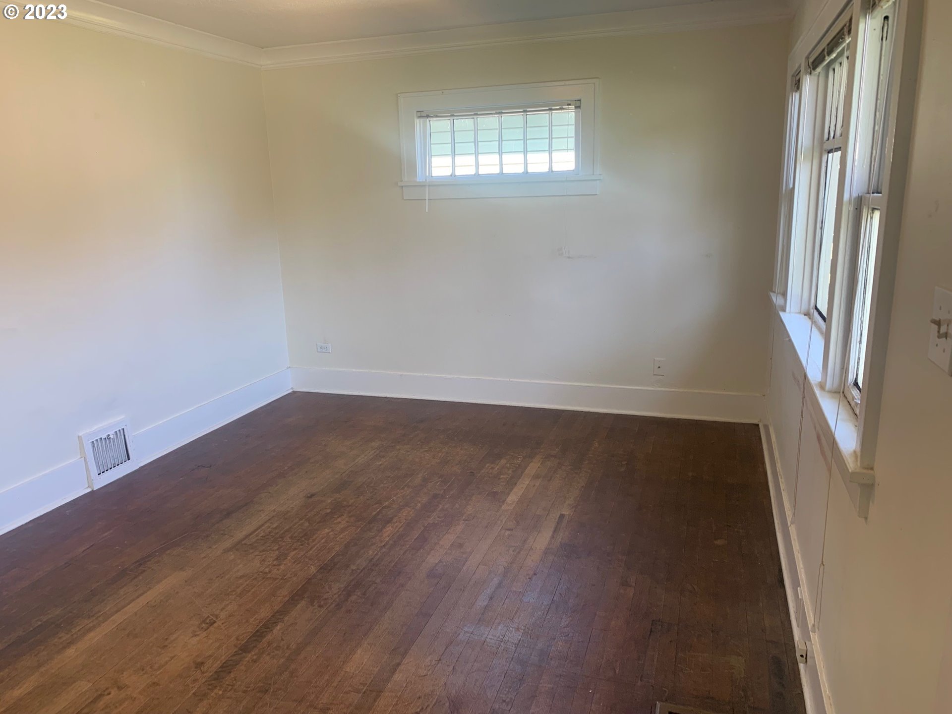 4005 Northeast 70th Avenue Portland, OR 97213 - Photo 3 of 27 an empty room with wooden floor and windows