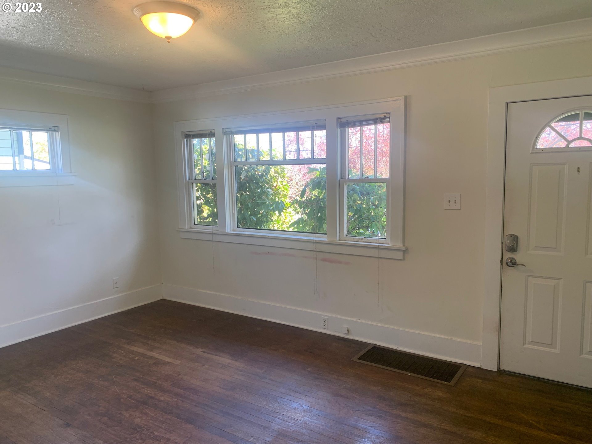 4005 Northeast 70th Avenue Portland, OR 97213 - Photo 4 of 27 a view of a room with wooden floor and windows in it