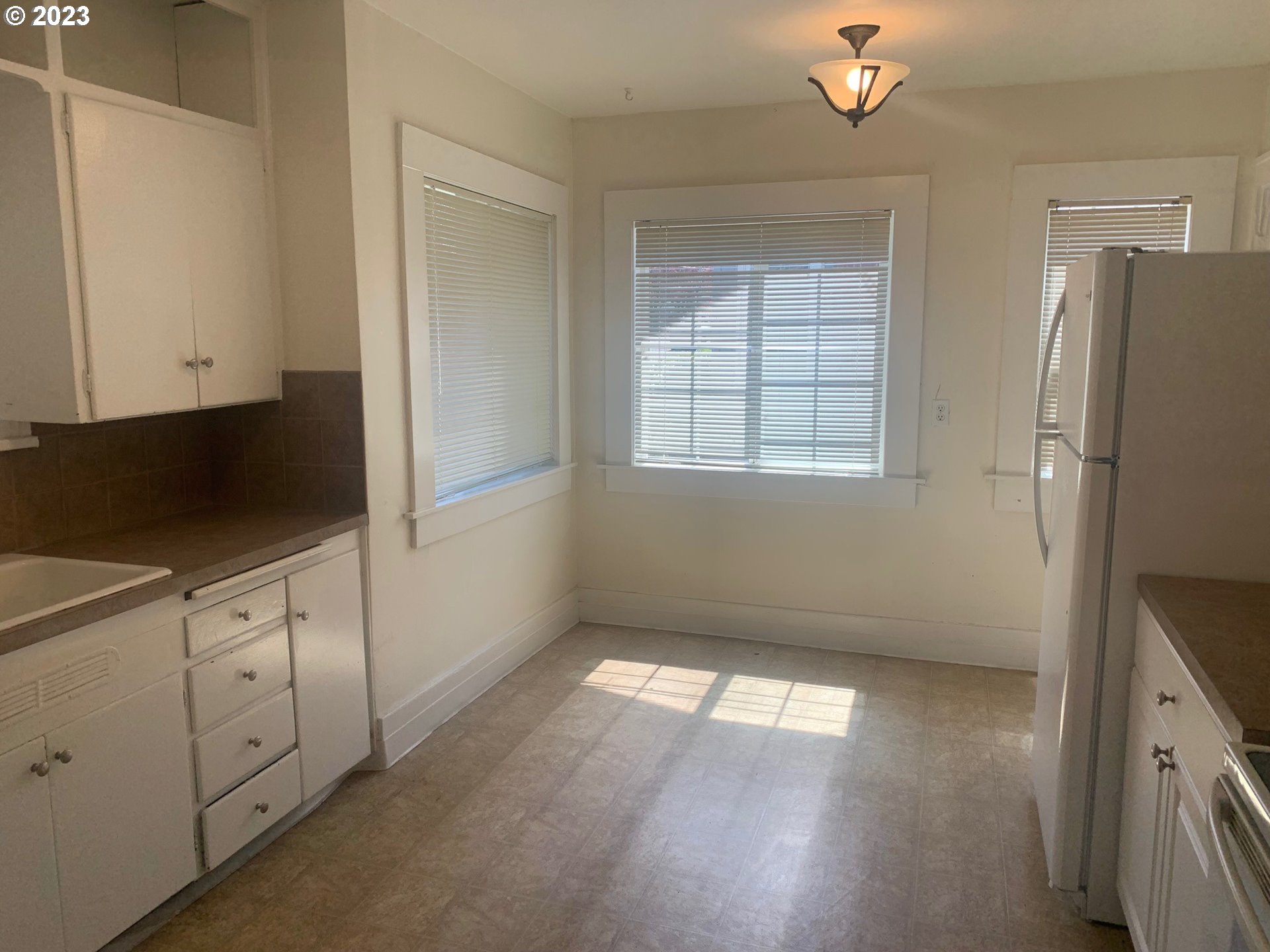 4005 Northeast 70th Avenue Portland, OR 97213 - Photo 7 of 27 a view of an empty room with a window and wooden floor