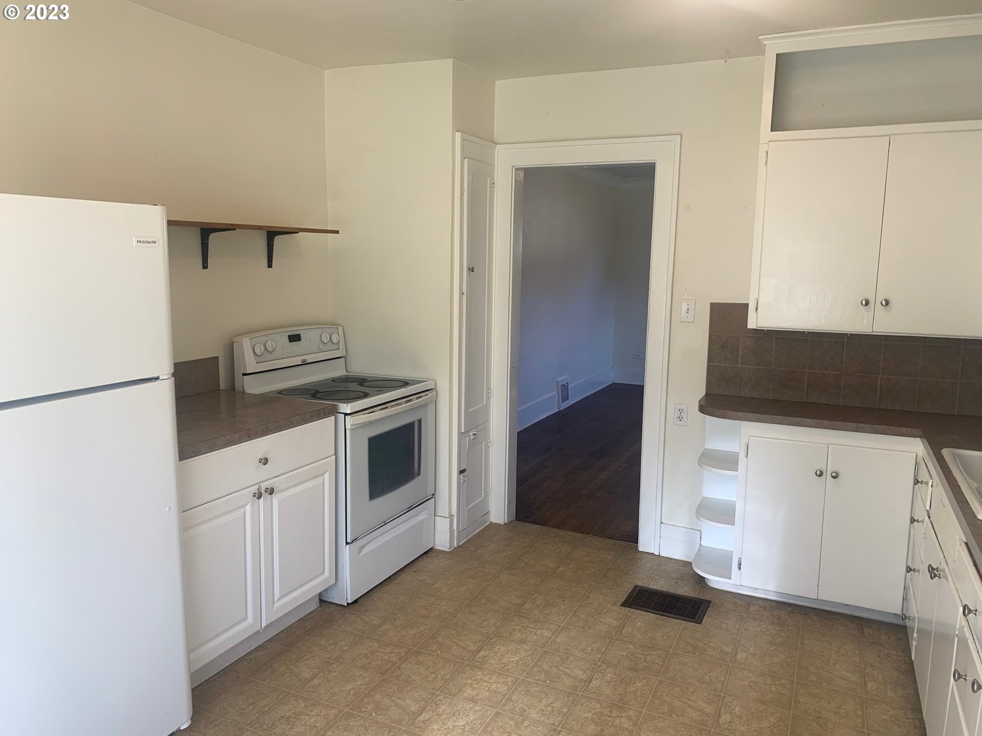 4005 Northeast 70th Avenue Portland, OR 97213 - Photo 8 of 27 a kitchen with white cabinets and white appliances