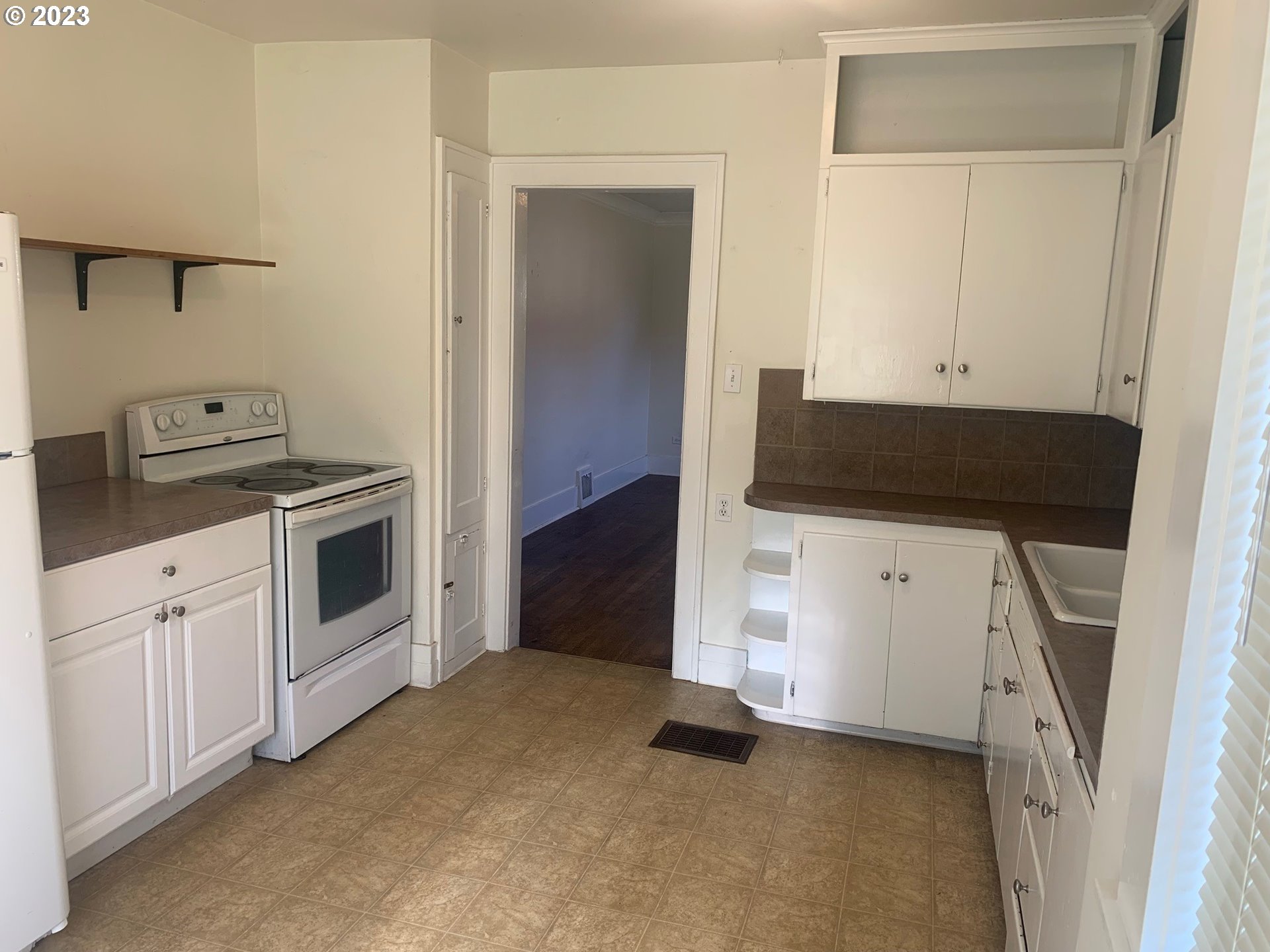 4005 Northeast 70th Avenue Portland, OR 97213 - Photo 9 of 27 a kitchen with white cabinets and white appliances