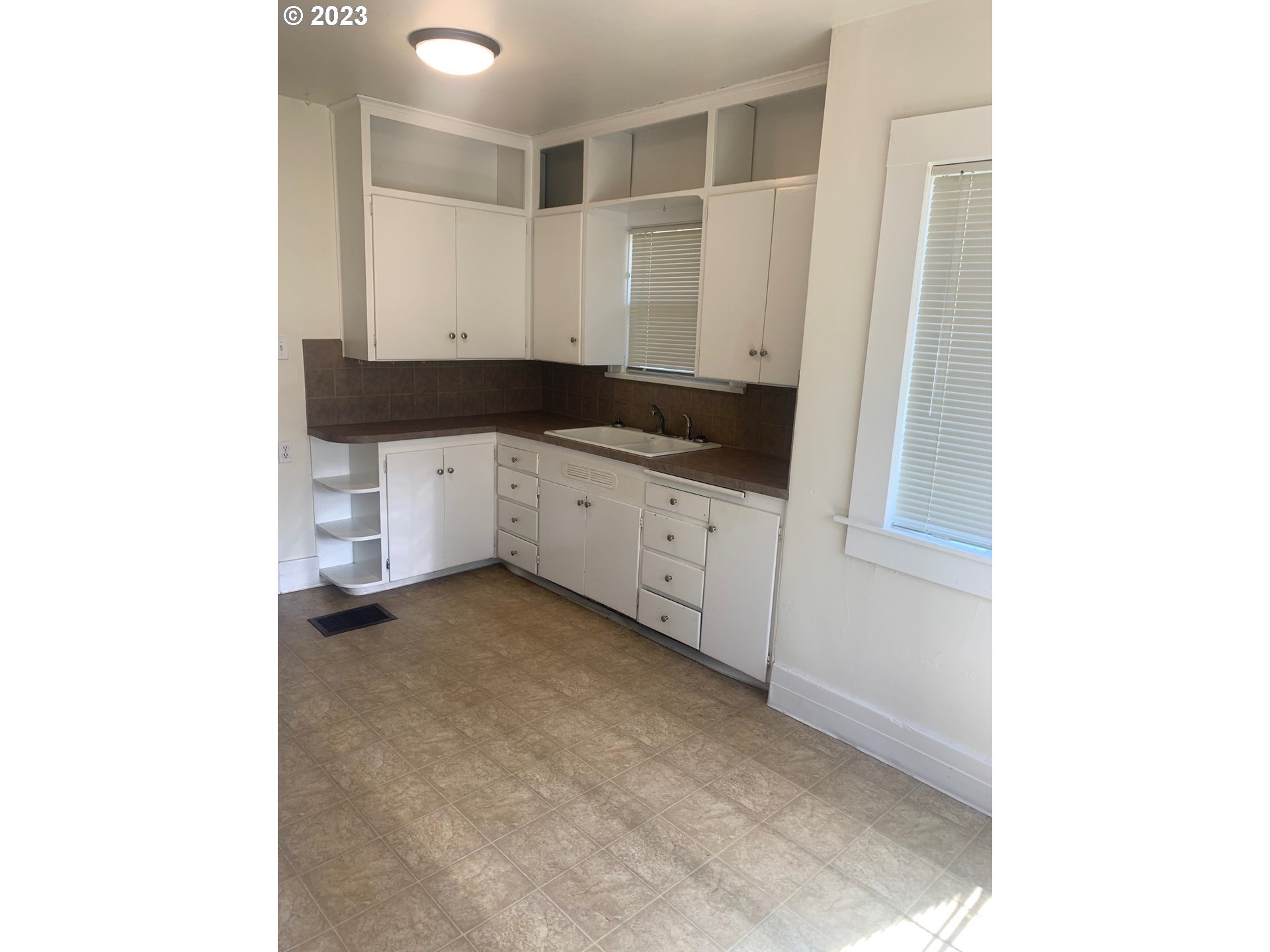 4005 Northeast 70th Avenue Portland, OR 97213 - Photo 10 of 27 a kitchen with granite countertop white cabinets and sink
