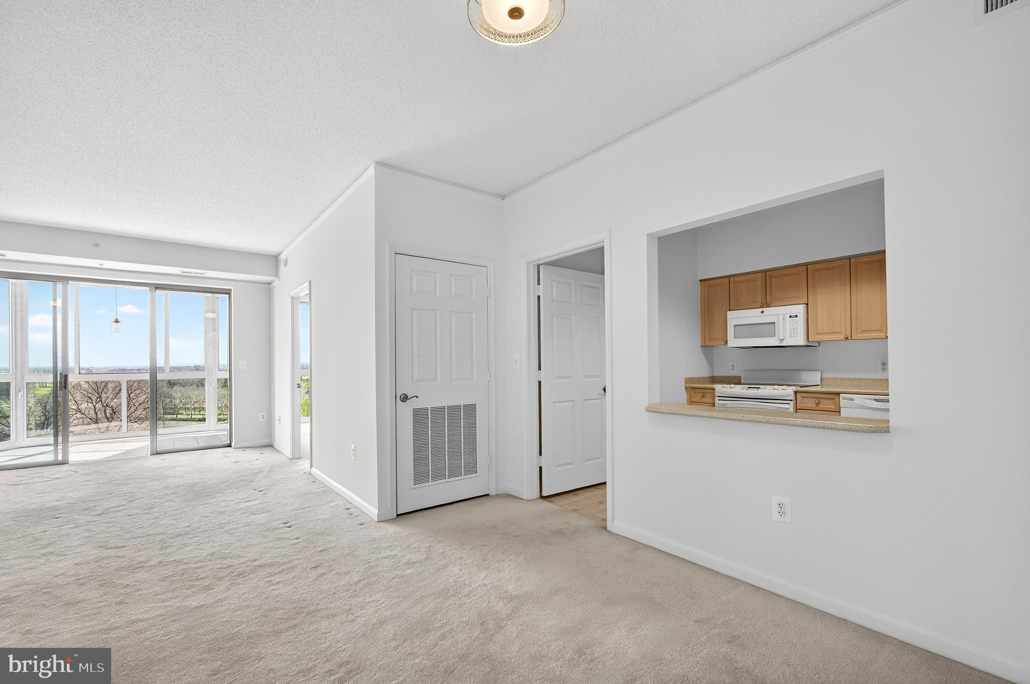 19355 Cypress Ridge Terrace, Unit 1122 Leesburg, VA 20176 - Photo 17 of 71 a view of a livingroom with wooden floor and a ceiling fan