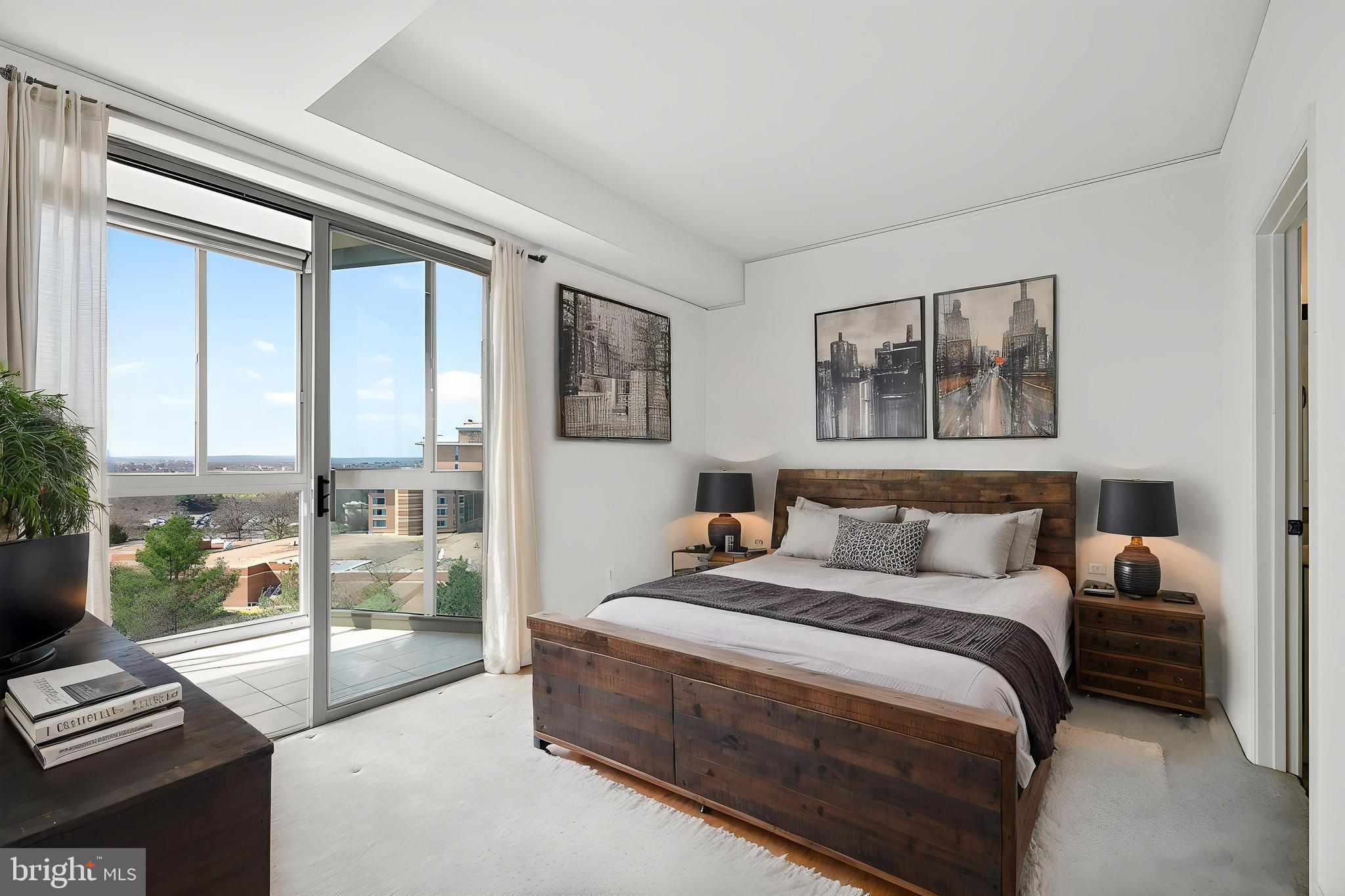 19355 Cypress Ridge Terrace, Unit 1122 Leesburg, VA 20176 - Photo 19 of 71 a bedroom with a bed and a night stand