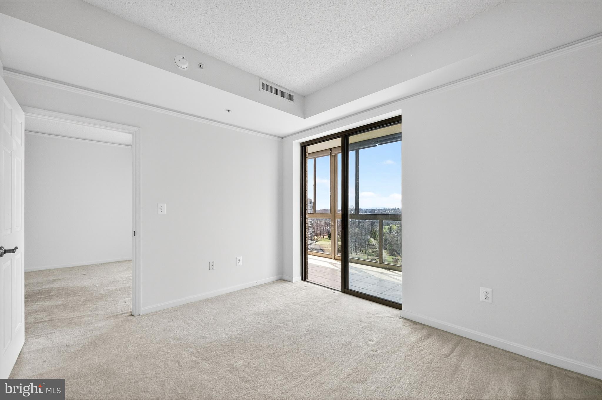 19355 Cypress Ridge Terrace, Unit 1122 Leesburg, VA 20176 - Photo 21 of 71 a view of an empty room with glass door