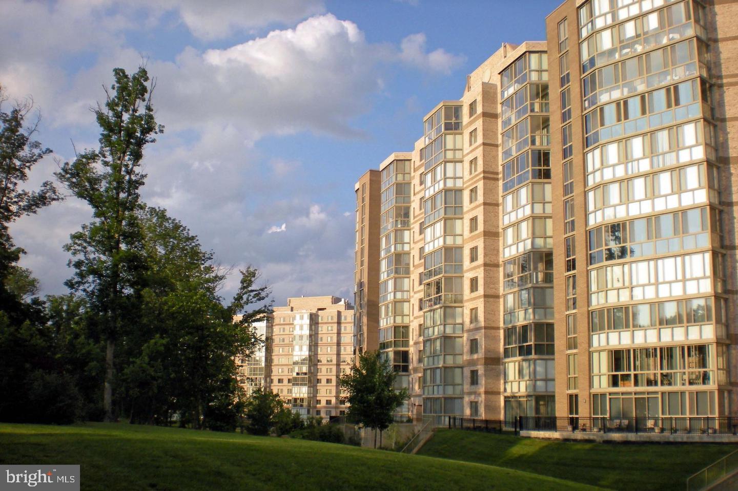 19355 Cypress Ridge Terrace, Unit 1122 Leesburg, VA 20176 - Photo 3 of 25 a view of a tall building with a yard
