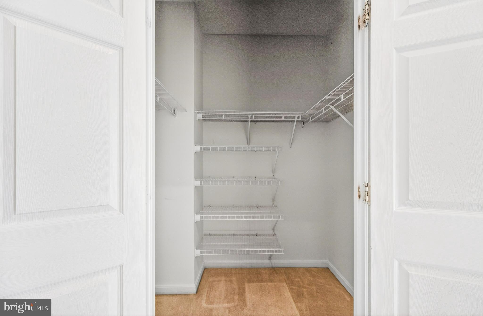 19355 Cypress Ridge Terrace, Unit 1122 Leesburg, VA 20176 - Photo 38 of 71 a view of walk in closet with empty racks