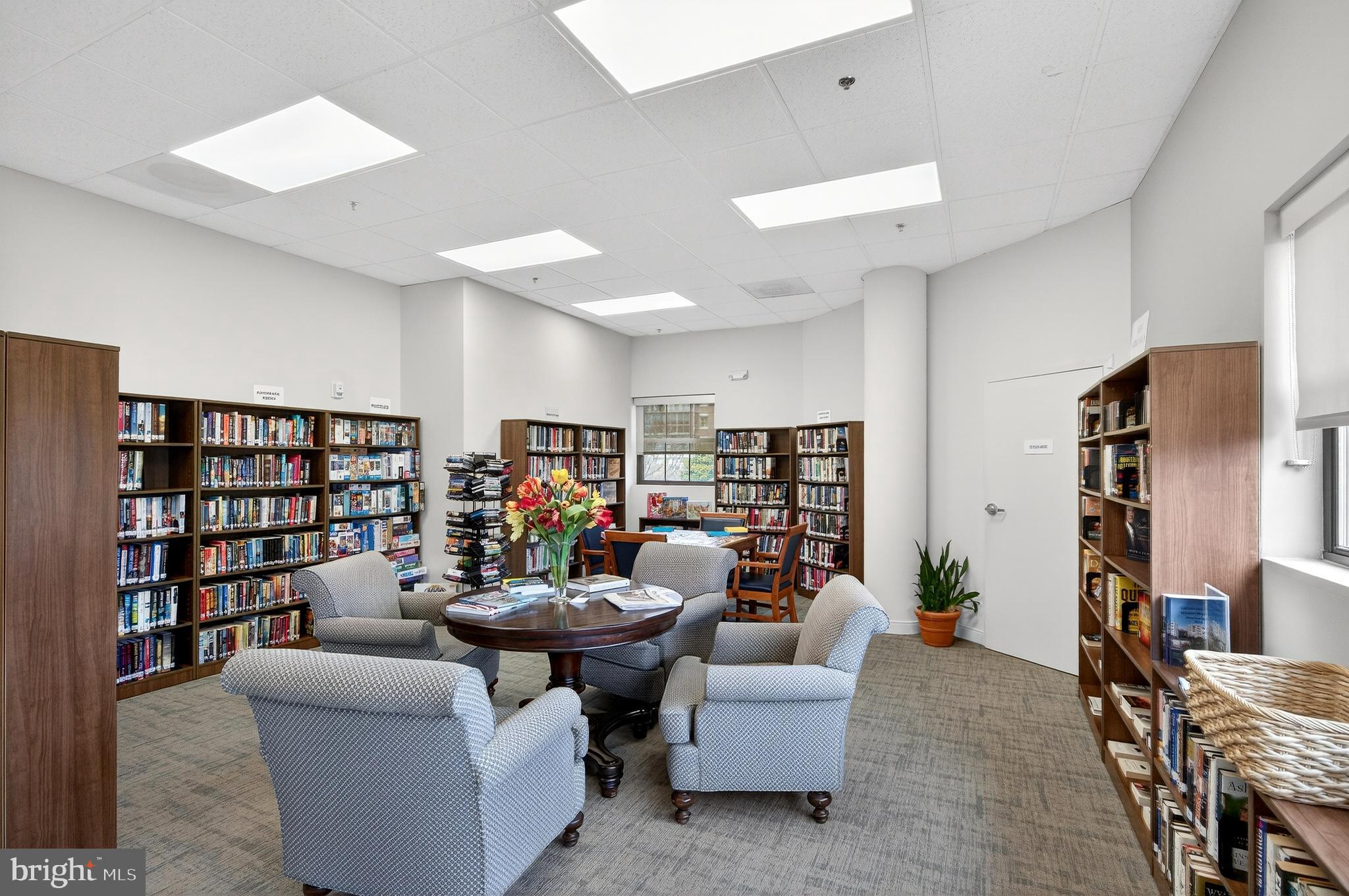 19355 Cypress Ridge Terrace, Unit 1122 Leesburg, VA 20176 - Photo 53 of 71 a living room with furniture and a book shelf