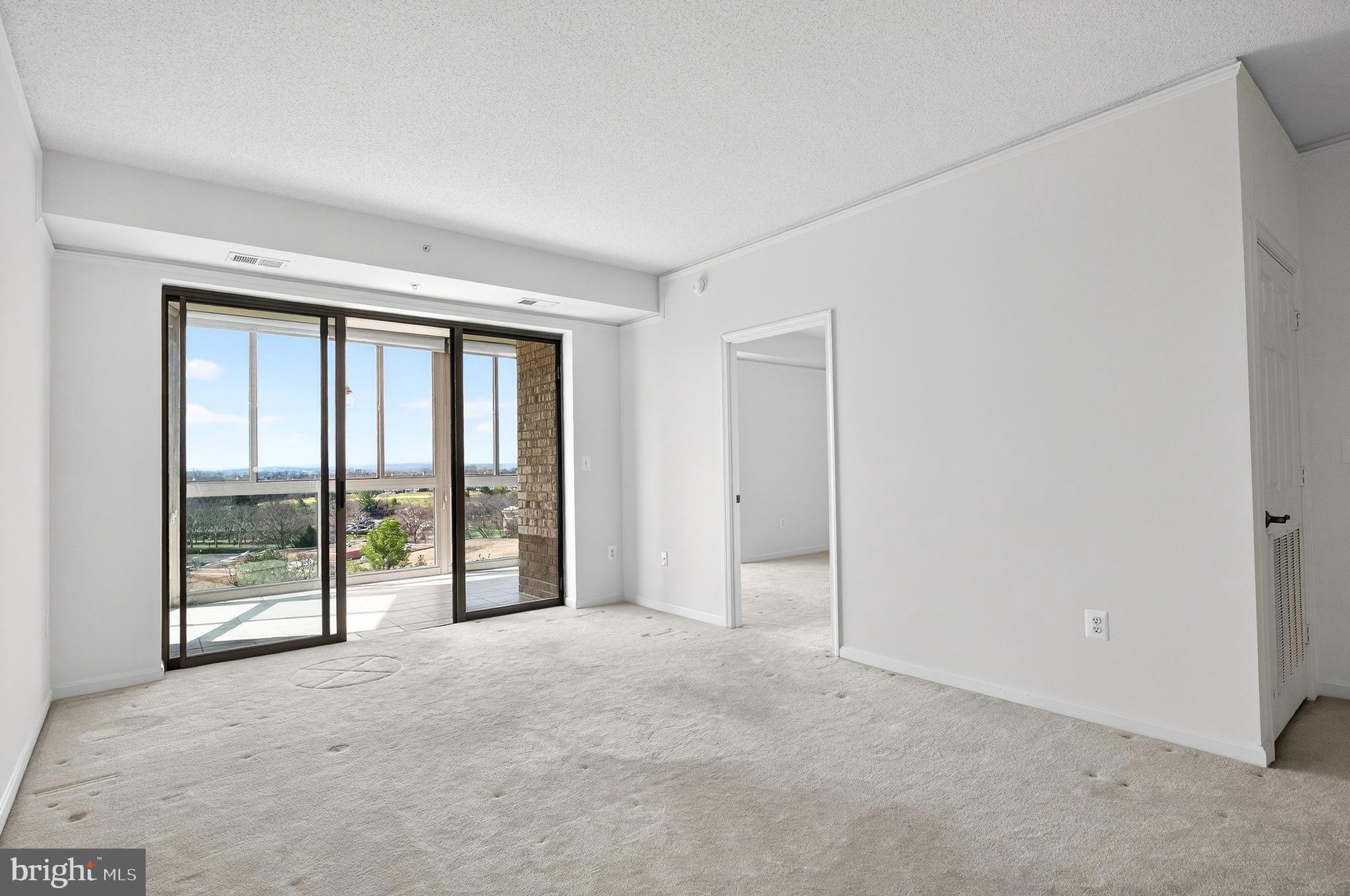 19355 Cypress Ridge Terrace, Unit 1122 Leesburg, VA 20176 - Photo 9 of 71 a view of an empty room with glass door